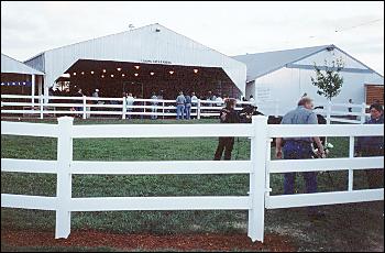 Picture of large fenced grassy show ring area.